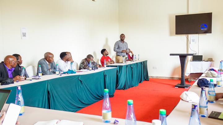 Nelson addressing fellow alumni at a meeting