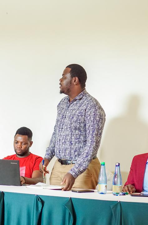 Nelson standing to speak during an alumni meeting