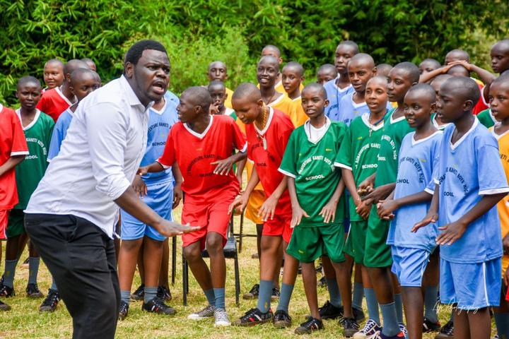 A mentor leading students in a coordinated outdoor activity