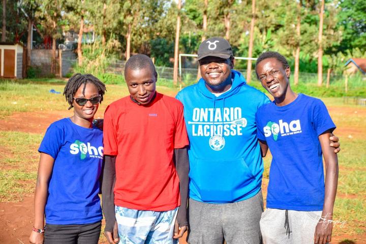 Mentors and young people smiling together after an outdoor activity