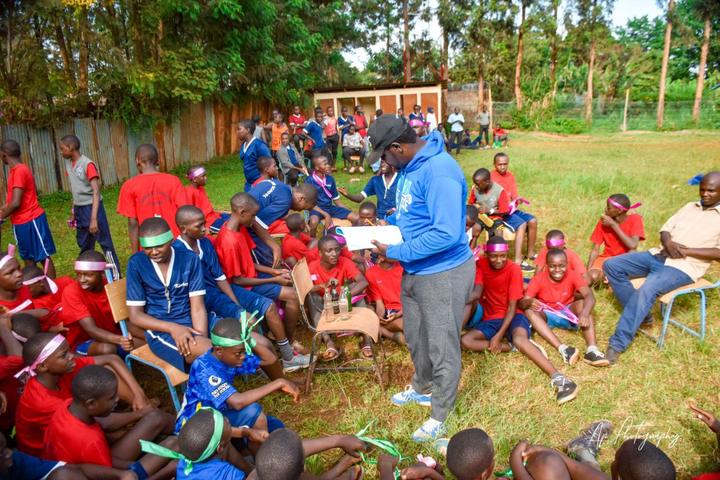 A mentor guiding teenagers in a team-building activity outdoors