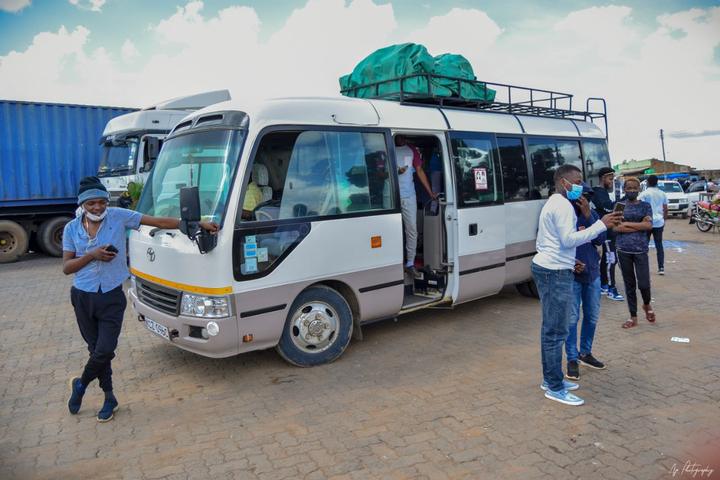 A minibus loaded and ready for the trip, with the team beside it
