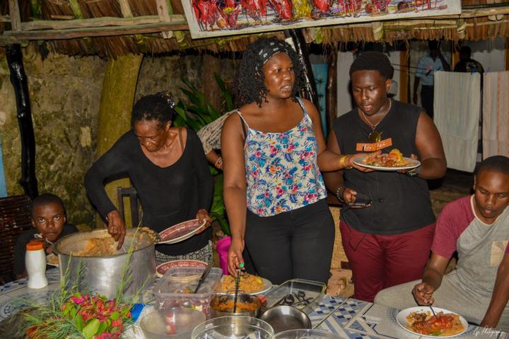 Mentees helping with food during a shared meal