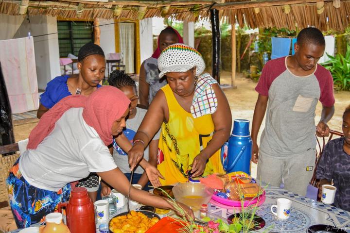 Young people and adults serving food at the venue