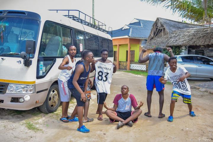 Young people outside the minibus at the coast