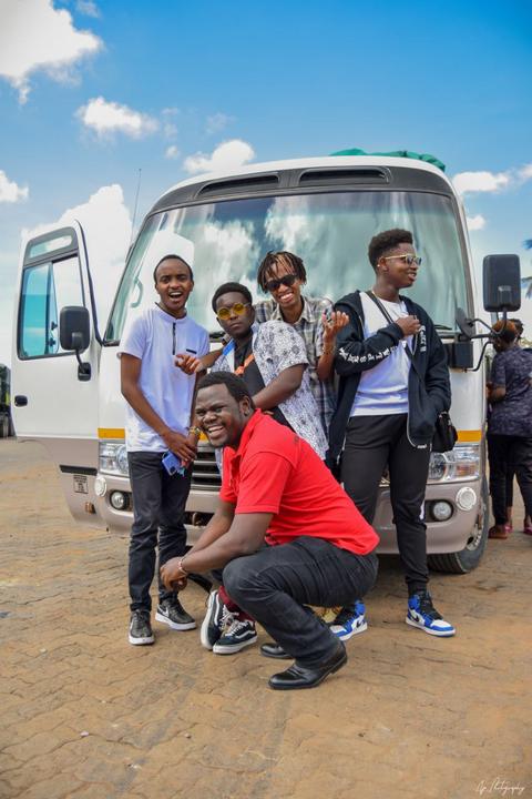 Mentees posing in front of their minibus
