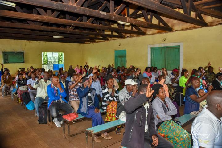 Participants raising their hands during a group discussion