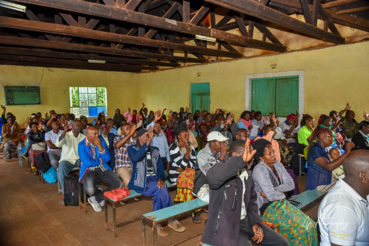 Participants raising their hands during a group discussion
