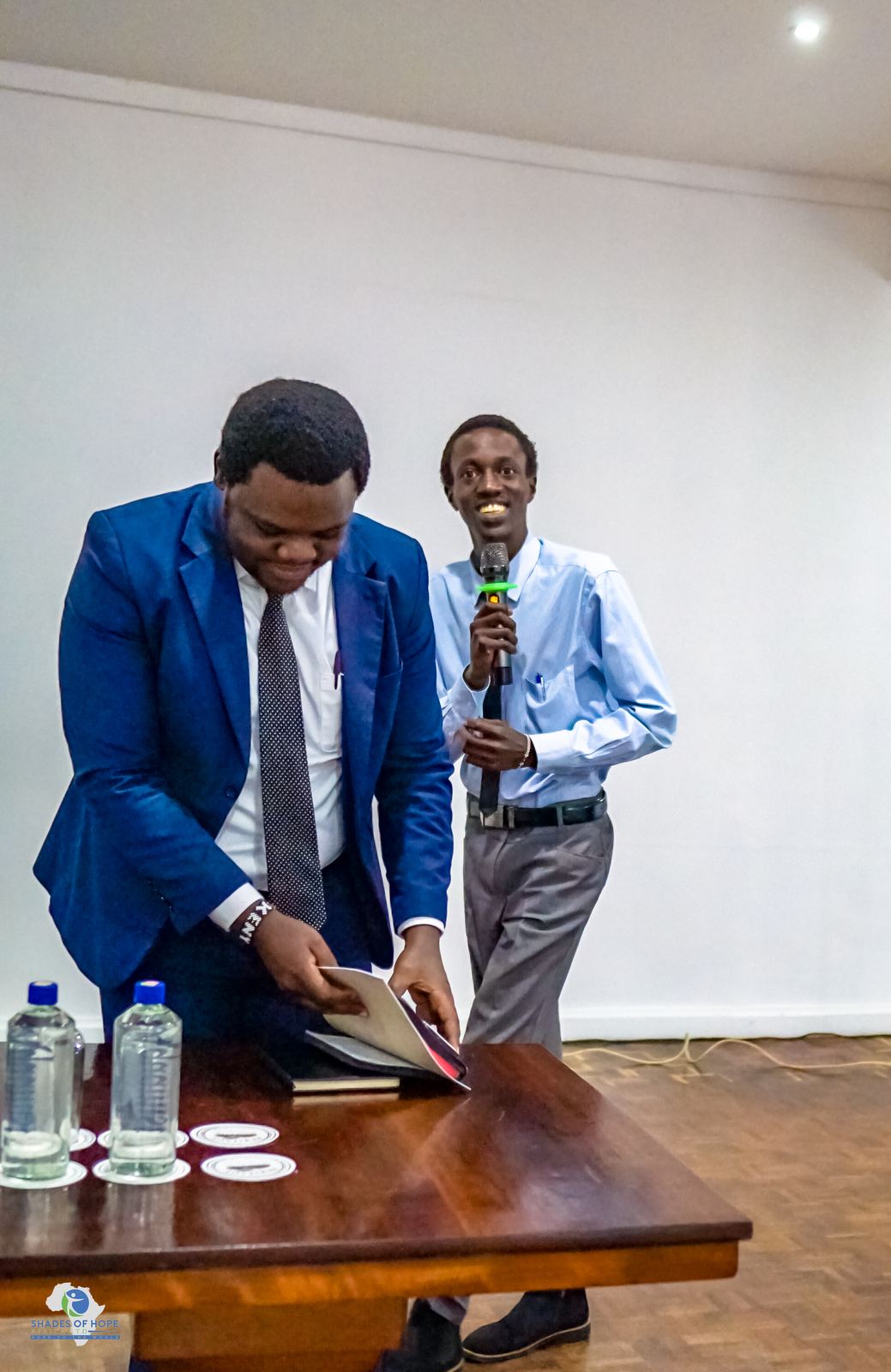 A young man speaking into a microphone at a youth conference