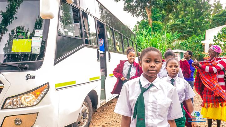 Students in uniform boarding a bus